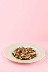 grilled octopus on a plate with sauce and spices