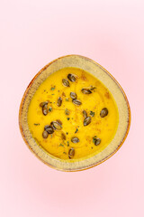 pumpkin porridge in a bowl decorated with seeds
