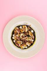 grilled octopus on a plate with sauce and spices