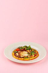 hummus with flatbread in a plate decorated with herbs and chickp