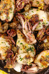 grilled octopus on a plate with sauce and spices