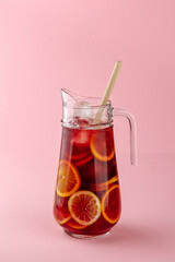 Spanish sangria in a decanter with citrus fruits and ice