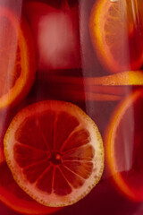 Spanish sangria in a decanter with citrus fruits and ice