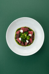 warm salad with steak, vegetables and sauce