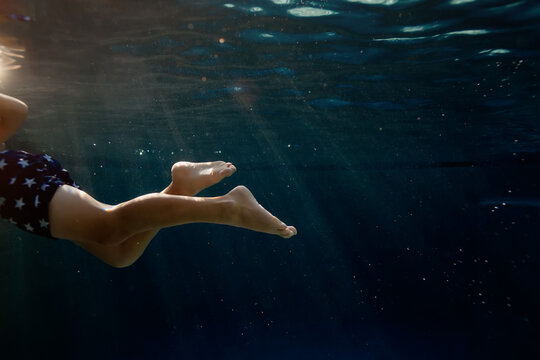 Young boy swimming in tranquil blue depths