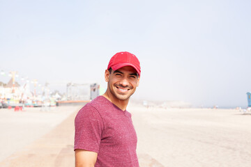 man smiling in red cap