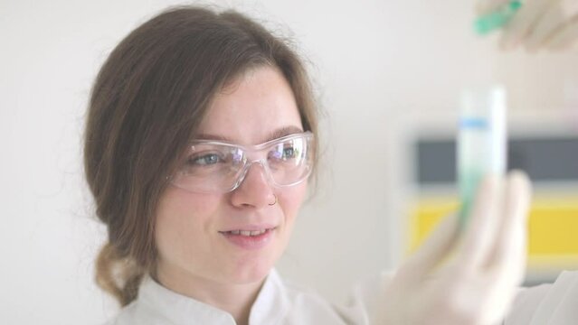 scientist female working with lab glasses and lab gloves