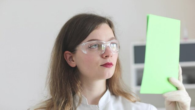 scientist female working with lab glasses and lab gloves