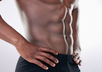 Black man, fitness and abs of bodybuilder in closeup for aesthetic human body isolated in studio....