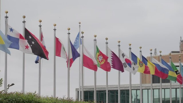 Line of national flags waving in front of the United Nations headquarters in New York City