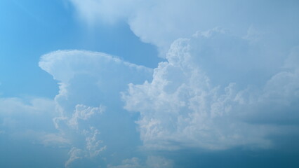 Withe clouds in a blue sky. White fluffy cumulonimbus clouds forming before thunderstorm. Timelapse.