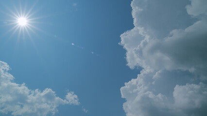 Rays of sun through clouds. Blue sky with cloudscape backlit bright sunlight through summer....
