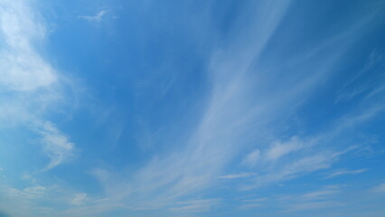 Summer sky. Cirrus clouds on bright blue sky. Wispy cirrus clouds pass over blue sky in nature. Timelapse.
