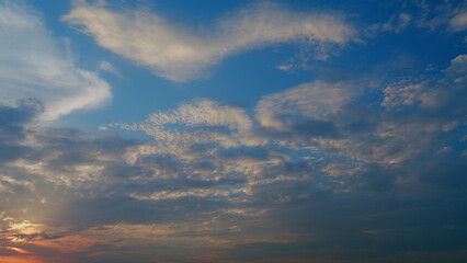 Hot sun with silhouettes of evening clouds. Colorful sky in evening. Timelapse.