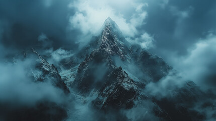 A mountain range covered in clouds with a snow-covered peak - Powered by Adobe