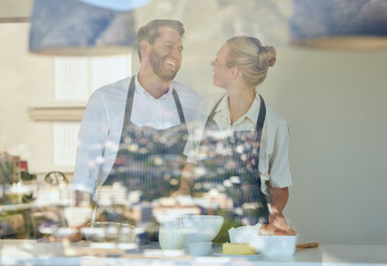 Couple, cooking and window in home at kitchen with happiness for learning recipe together on...