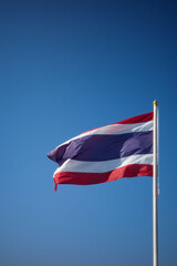 Flag of Thailand national against blue sky waving with pride colorful background