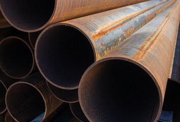 rusty steel pipes stacked on a construction site