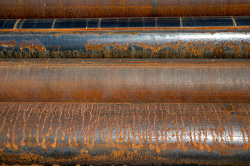 rusty steel pipes stacked on a construction site