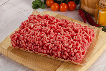 Raw minced beef meat over board