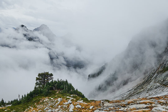 Misty mountaintops and fast moving clouds surround Vesper peak i
