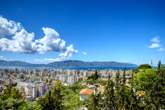 Panorama of Vlora City in Albania from Kuzum Baba view point in summer sunny day with blue sky and clouds