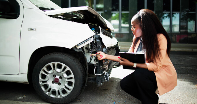 African American Car Insurance Agent Inspecting Accident