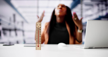 Thermometer In Front Of Businesswoman Working During Hot Weather
