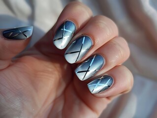 Fototapeta premium A person holding up a nail with a silver and black design.