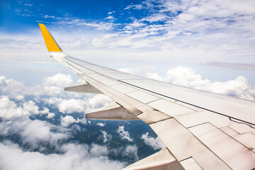 Vintage color tone of Wing of an airplane flying above the ocean. Photo applied to tourism...