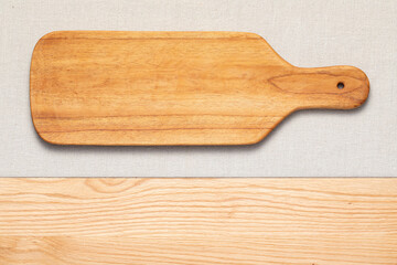 Handmade long wooden cutting board on the countertop. Long wooden pallet.