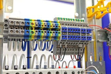 Electrical pass-through terminals for connecting copper mounting wires in an electrical distribution cabinet.