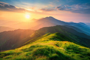 a sunset over a mountain range with a green grass covered hill in the foreground
