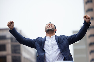 Businessman, happy and celebration for success in city with arms up for personal triumph, business expansion and recognition. Man, outdoor and cheer for career milestone and promotion achievement.