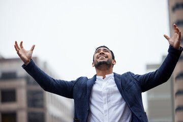 Businessman, happy and celebration for success in city with arms up for personal triumph, business expansion and recognition. Man, outdoor and cheer for career milestone and promotion achievement.