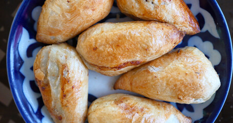 Delicious Uzbek Samsa with lamb and spices cooked in tandoor.
