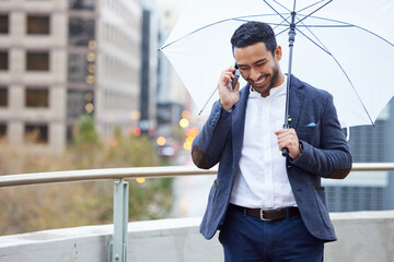 Businessman, phone call and umbrella with communication in city for justice, advocate for legal with tech. Male lawyer, rain or parasol with conversation and mobile in urban, attorney in New York