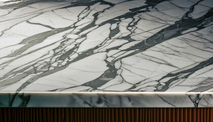 Fototapeta premium Elegant close-up of white marble with natural gold veins, suitable for background or design use.