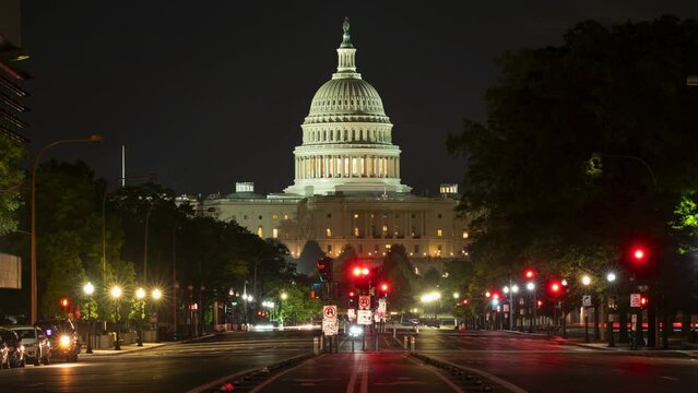 Timelapse of the United States Capitol at night time with cars driving down Pennsylvania Avenue