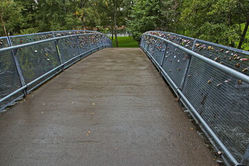 Footbridge with locks in Kuba Park in Oslo, Norway, Europe

