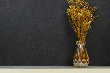 vase of Yellow and white baby's breath, gypsophila dry flowers on white wood table