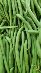 Close up pile of fresh long beans placed together in local market as a background.	