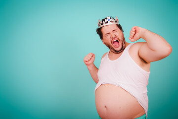 Funny football fan. Anger, joy and aggression. Fat man posing on a blue background.