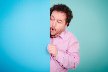 Business solutions. Anger, joy and aggression. Fat man posing on a blue background.