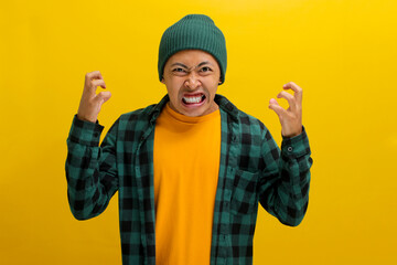 Angry young Asian man, dressed in a beanie hat and casual outfit, is shouting and yelling with...