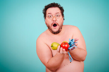 Funny fat man on a diet. Proper nutrition and bad habits. Blue background.