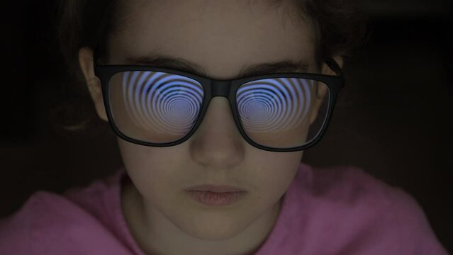 Child Girl With Glasses Watching Hypnotic Screen. Influence of Media on People. Broadcast False Information, Hoax, Propaganda Brainwashing Disinformation. Manipulation Crowd Fakes, False Information.