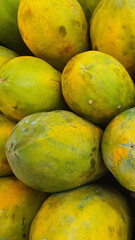 Close up pile of tasty fresh papaya sold at the market as a background.