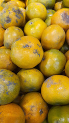 Close up pile of tasty fresh oranges sold at the market as a background.