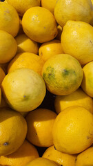 Close up pile of tasty fresh limes sold at the market as a background.